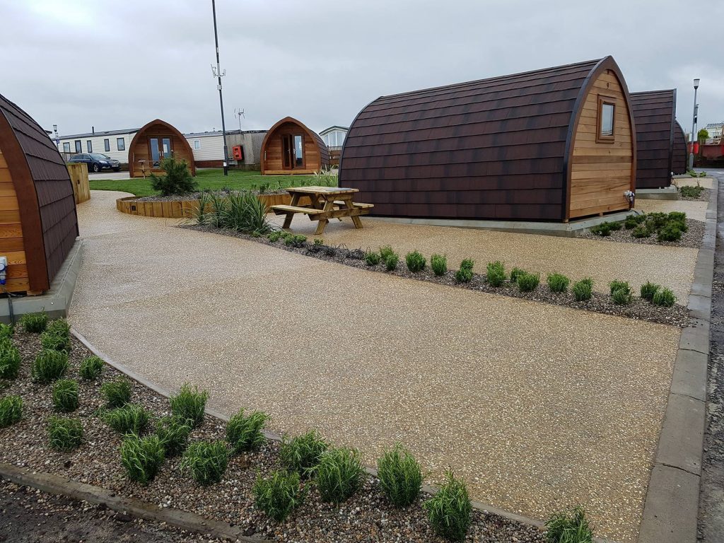 An image of a landscaping job we did with paving and sheds through a modern complex
