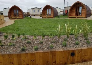 An image of a landscaping job we did with paving and sheds through a modern complex