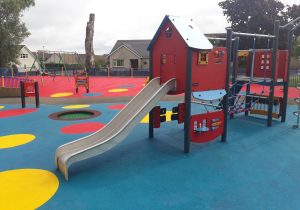 An Image of a play area with a small jungle gym and a slide we created