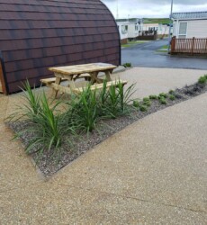 An image of a landscaping job we did with paving and sheds through a modern complex