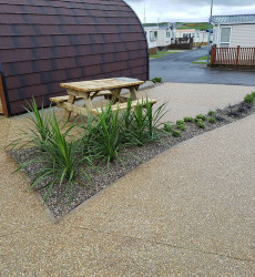 An image of a landscaping job we did with paving and sheds through a modern complex