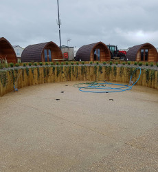 An image of a landscaping job we did with paving and sheds through a modern complex