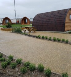 An image of a landscaping job we did with paving and sheds through a modern complex