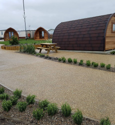 An image of a landscaping job we did with paving and sheds through a modern complex