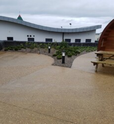 An image of a landscaping job we did with paving and sheds through a modern complex