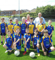 An image of a football pitch we constructed with a children's football team on it